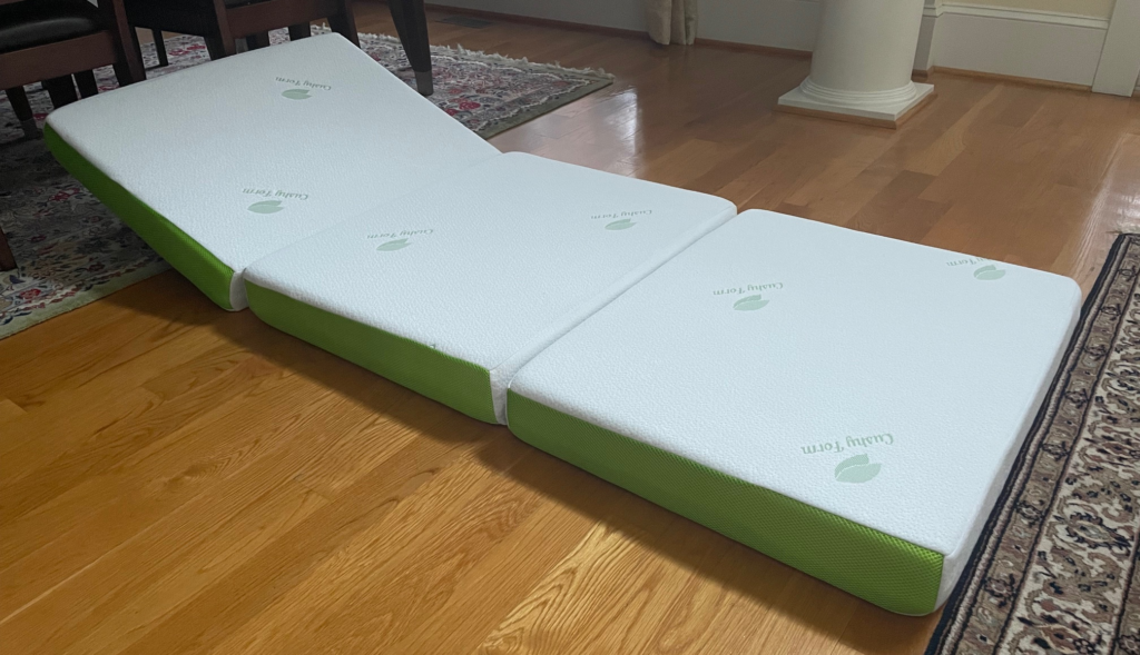 Memory foam folding mattress opened up in living area.